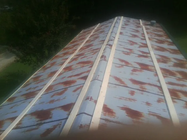 Rusted metal roof panels with new wood purlins before replacement — Storm Damage Roof Repair in Powhatan by Roofing Brothers